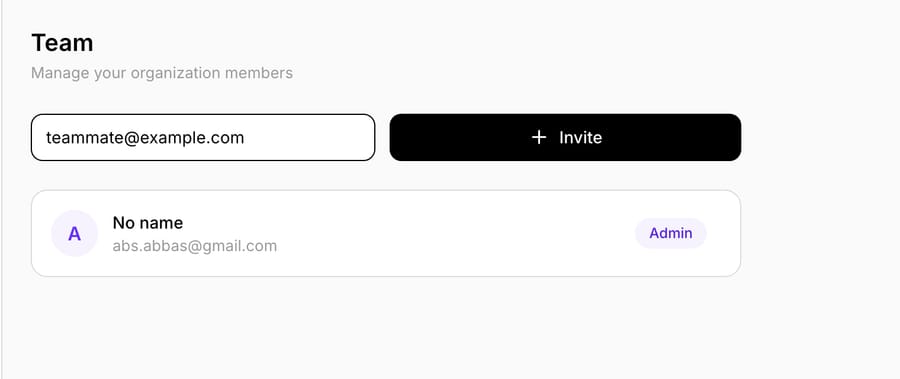 Settings → Team in Macha — invite a teammate by entering their email and clicking Invite; each existing member's role badge (here, Admin) lives on their row, where you manage it.