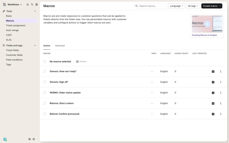 The Gorgias Macros library (Workflows → Tools → Macros): pre-made quick responses (Generic: How can I help?, Generic: Sign off, WISMO: Order status update, Returns: Start a return, Refund: Confirm processed) with tags, language and usage-count columns. The left Workflows nav shows the neighboring Rules tool — the macros-vs-rules decision point.