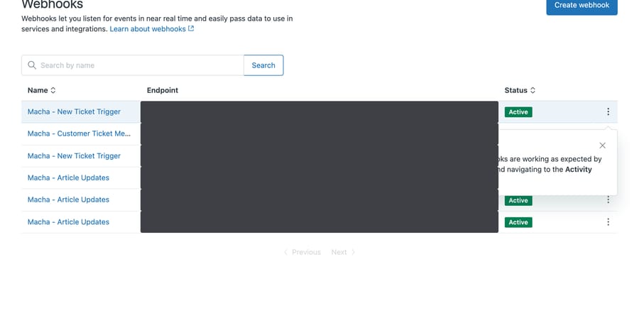 Zendesk webhooks list showing three webhooks named Macha - Article Updates and two named Macha - New Ticket Trigger, all active, with endpoint URLs redacted